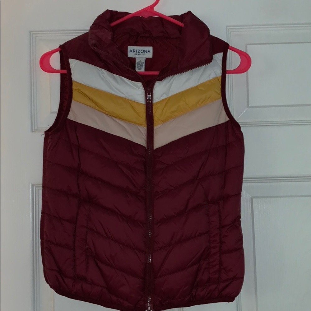 A maroon puffy vest